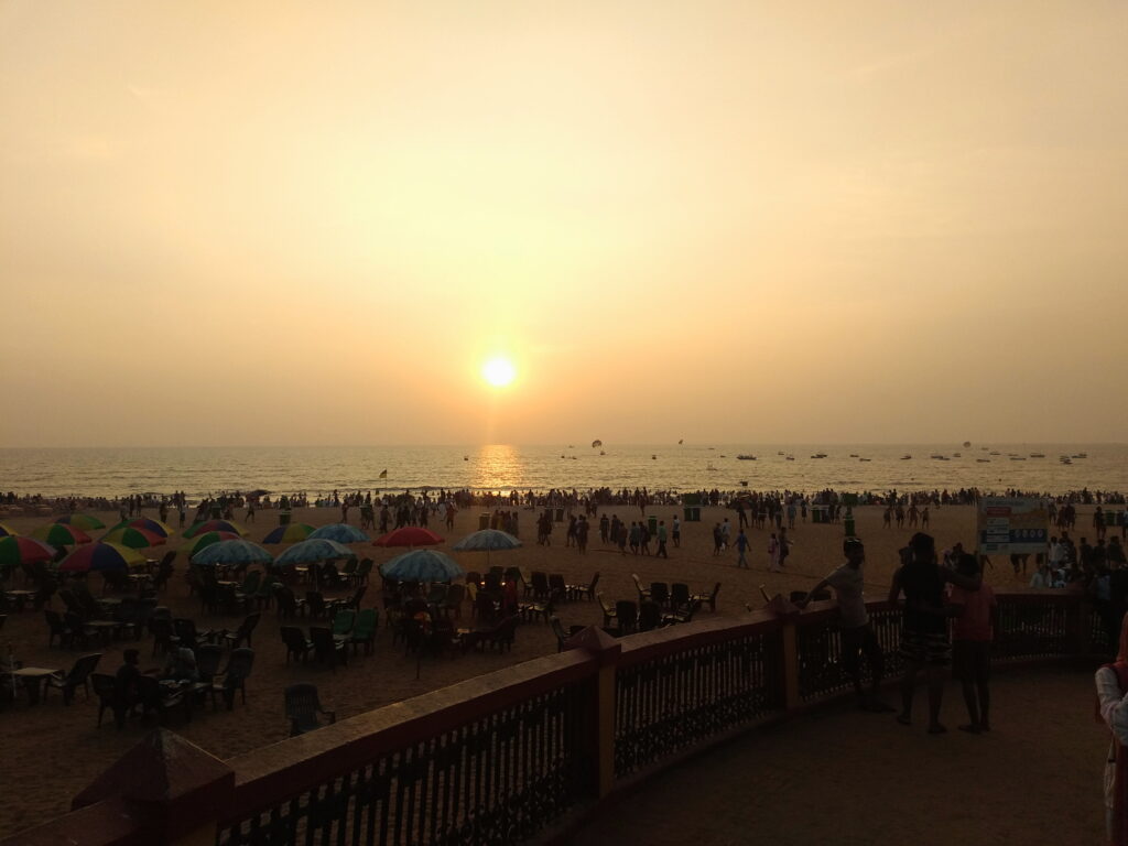 Visitors and boats on Calangute Beach in Goa.