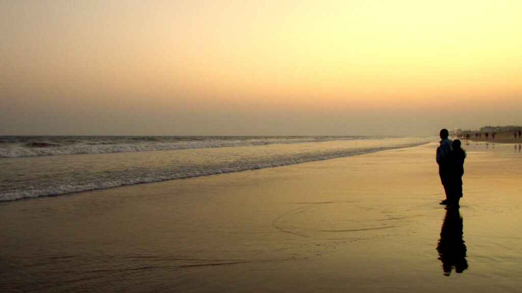 Visitors on Puri Beach beside the Bay of Bengal.